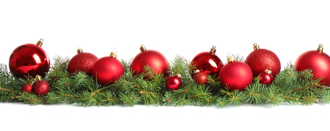 Photo of Fir tree branches with Christmas decoration on white background