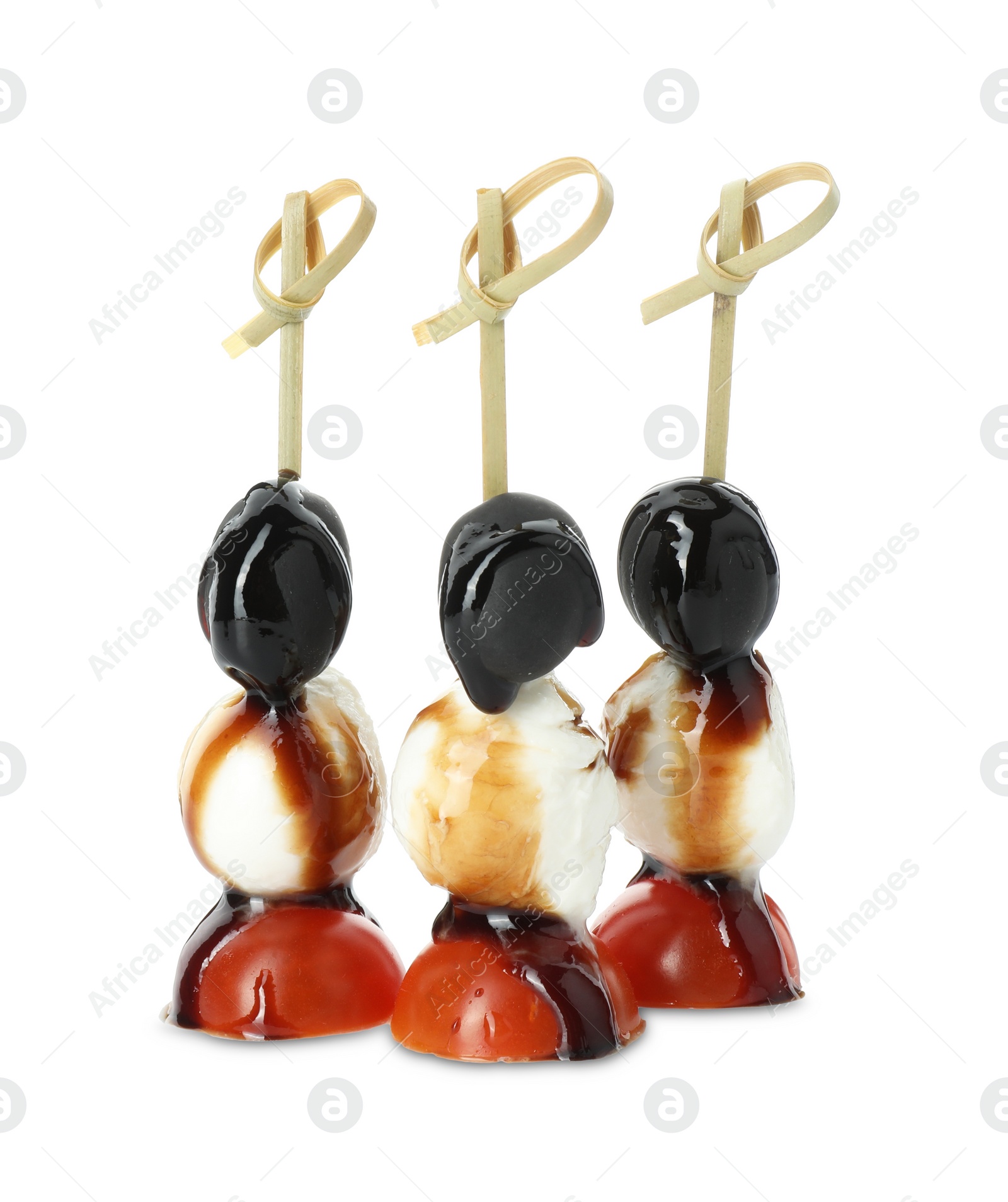 Photo of Tasty canapes with black olives, mozzarella and cherry tomatoes isolated on white