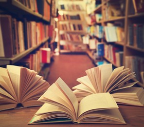 Image of Open books on wooden table in library