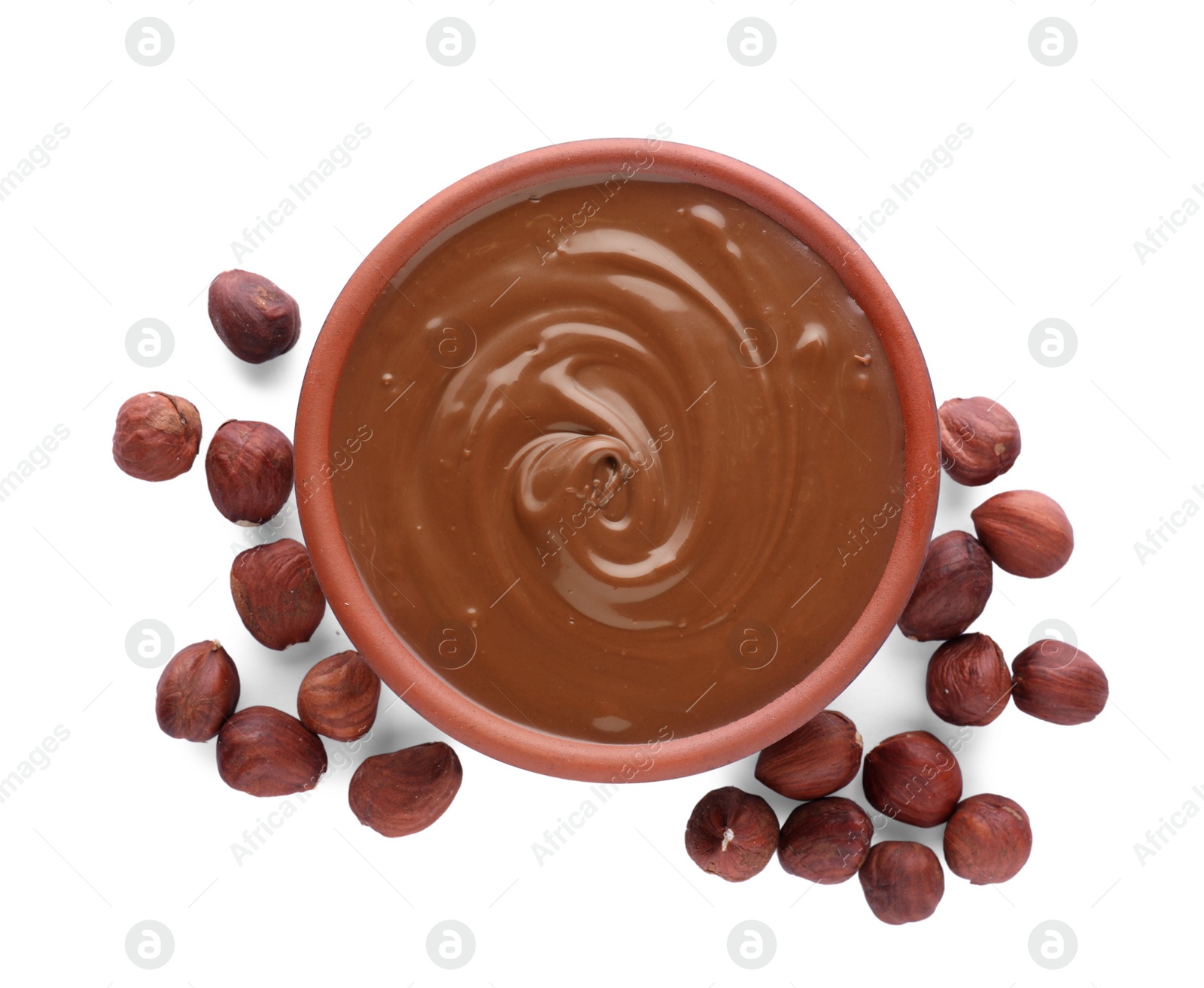 Photo of Bowl with delicious chocolate paste and hazelnuts on white background, top view