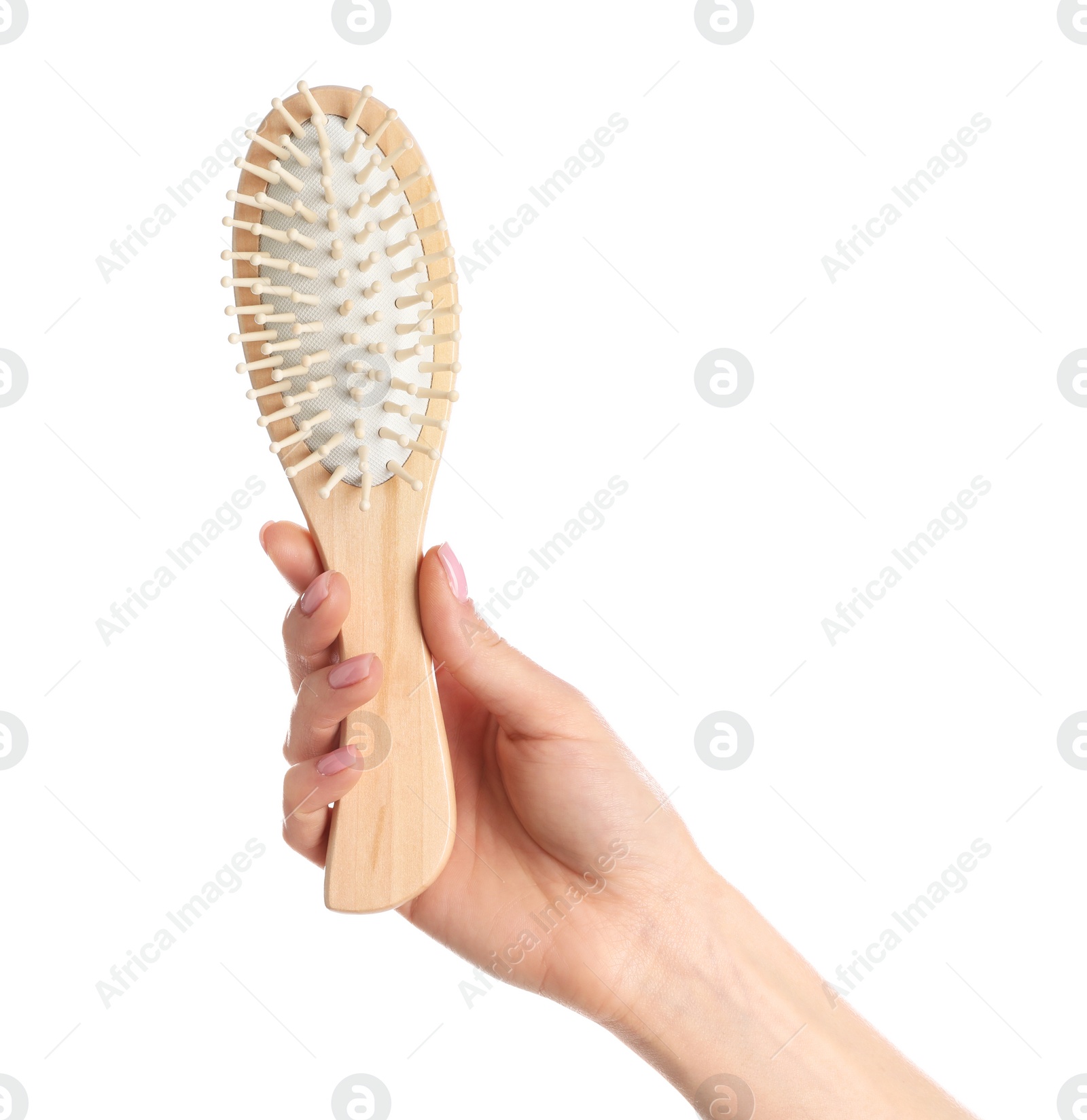 Photo of Woman holding wooden hair brush against white background, closeup