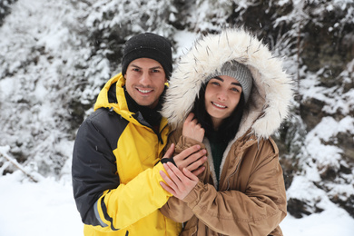 Lovely couple outdoors on snowy day. Winter vacation