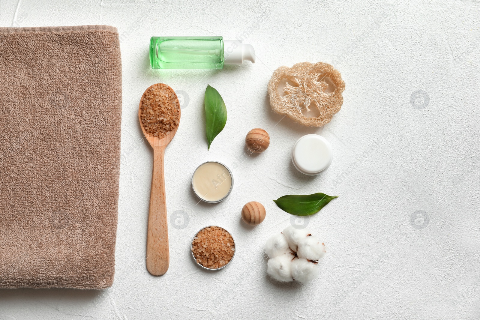 Photo of Flat lay composition with spa cosmetics and towel on white background