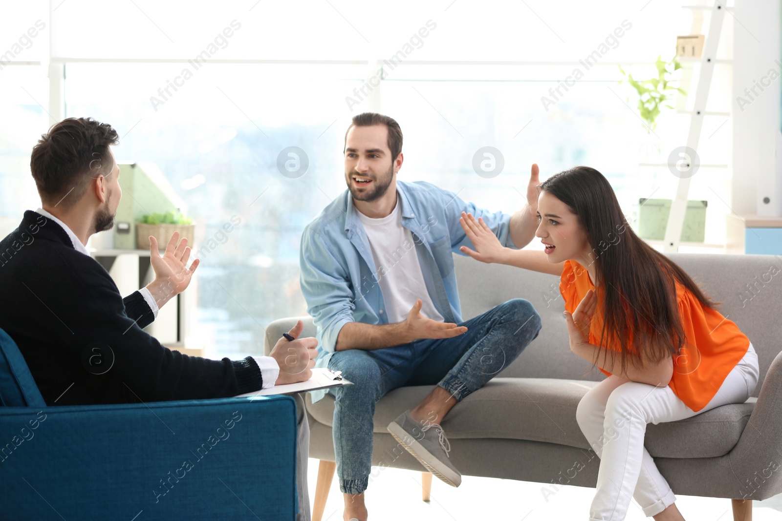 Photo of Family psychologist working with young couple in office