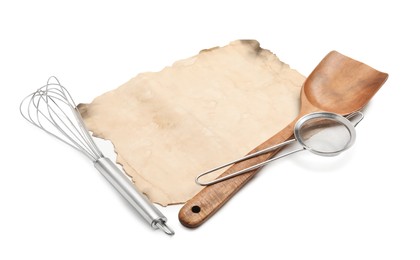 Photo of Old cookbook page and kitchen utensils on white background. Space for text