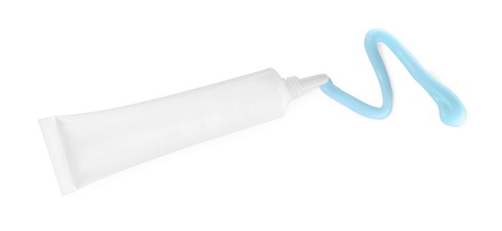 Photo of Tube with squeezed hand cream on white background, top view