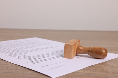 Photo of One stamp tool and document on wooden table