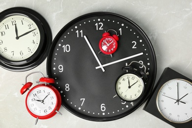 Photo of Many different clocks, top view. Time change concept