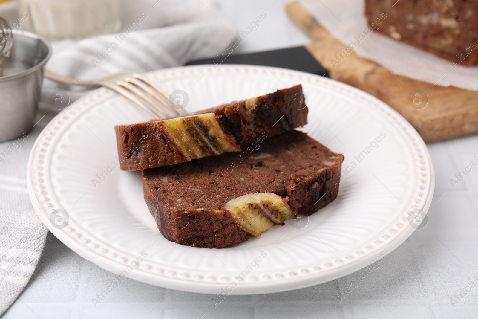 Photo of Slices of delicious banana bread served on table, closeup