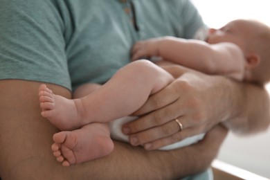 Photo of Father with his newborn son, closeup view