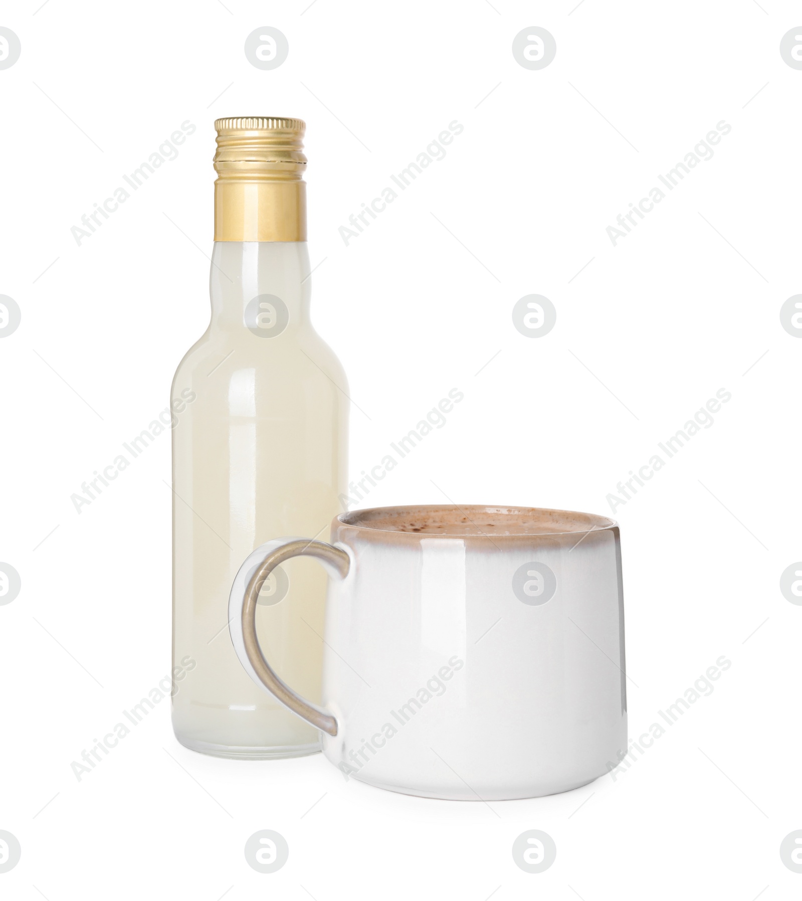 Photo of Bottle of delicious syrup and cup of coffee isolated on white