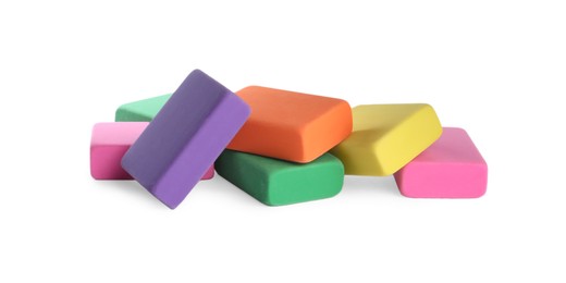 Photo of Pile of bright erasers on white background