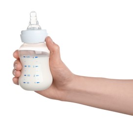 Woman holding feeding bottle with infant formula on white background, closeup