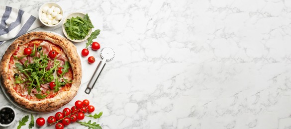 Tasty pizza with meat and arugula on white marble table, flat lay with space for text. Banner design