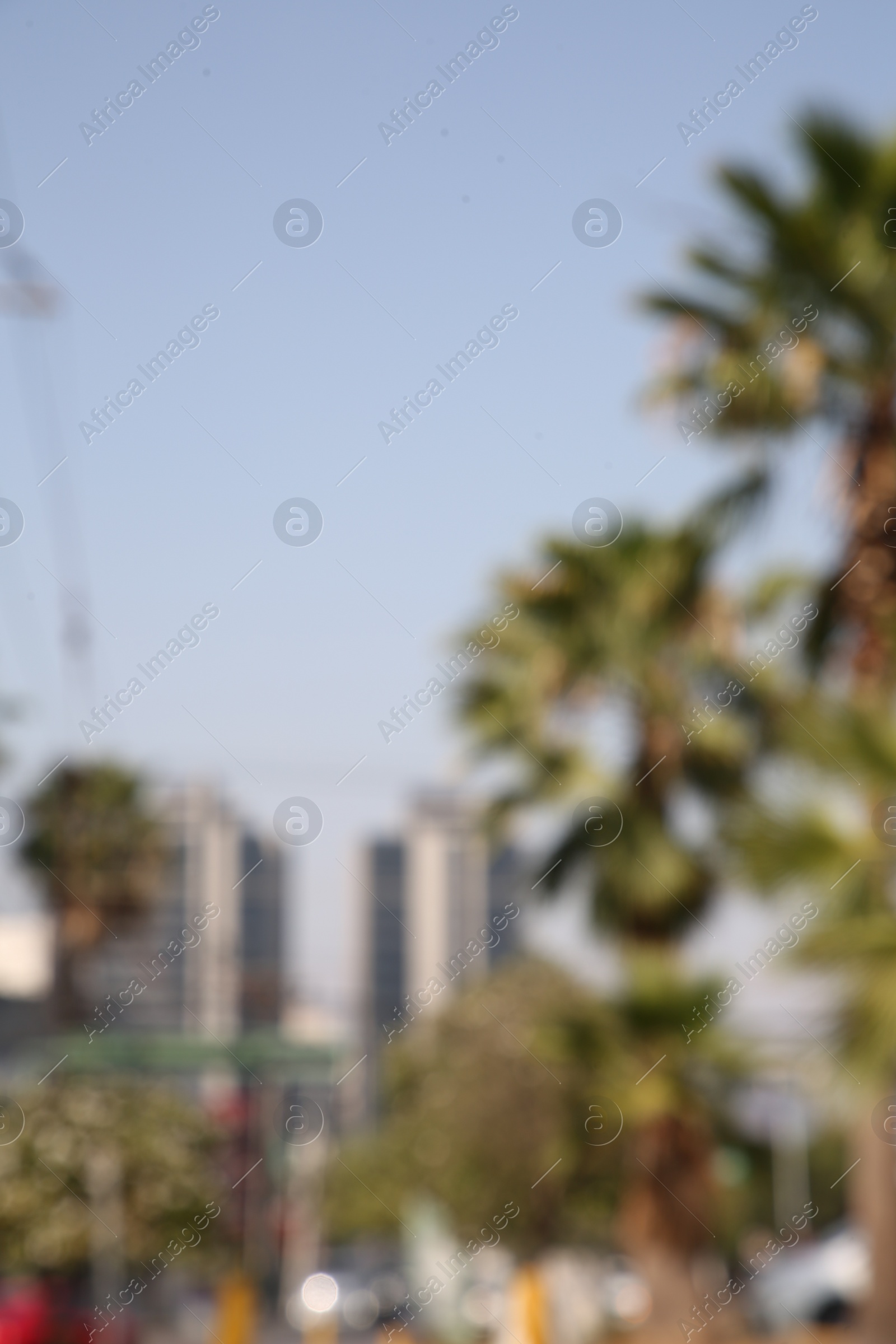 Photo of San Pedro Garza Garcia, Mexico – March 20, 2023: Blurred view of city with buildings and green palms