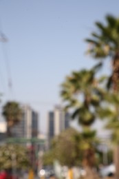 San Pedro Garza Garcia, Mexico – March 20, 2023: Blurred view of city with buildings and green palms