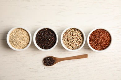 Photo of Flat lay composition with different types of quinoa on white wooden background