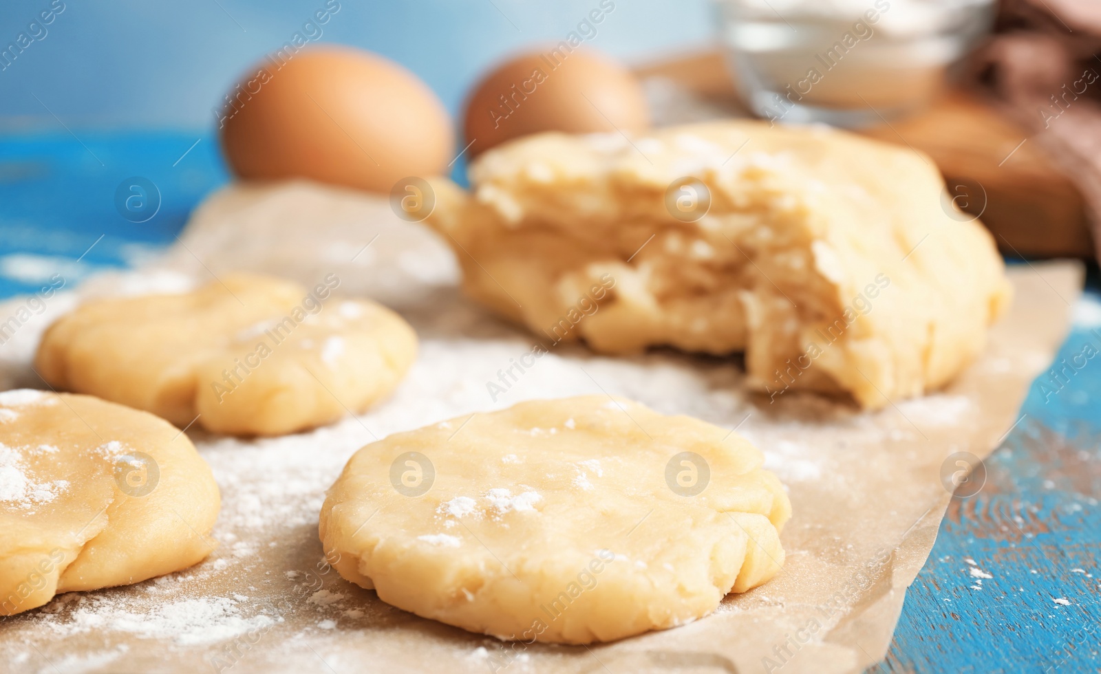 Photo of Pieces of fresh raw dough on table, closeup