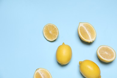 Photo of Many fresh ripe lemons on light blue background, flat lay. Space for text