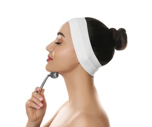 Photo of Woman using metal face roller on white background
