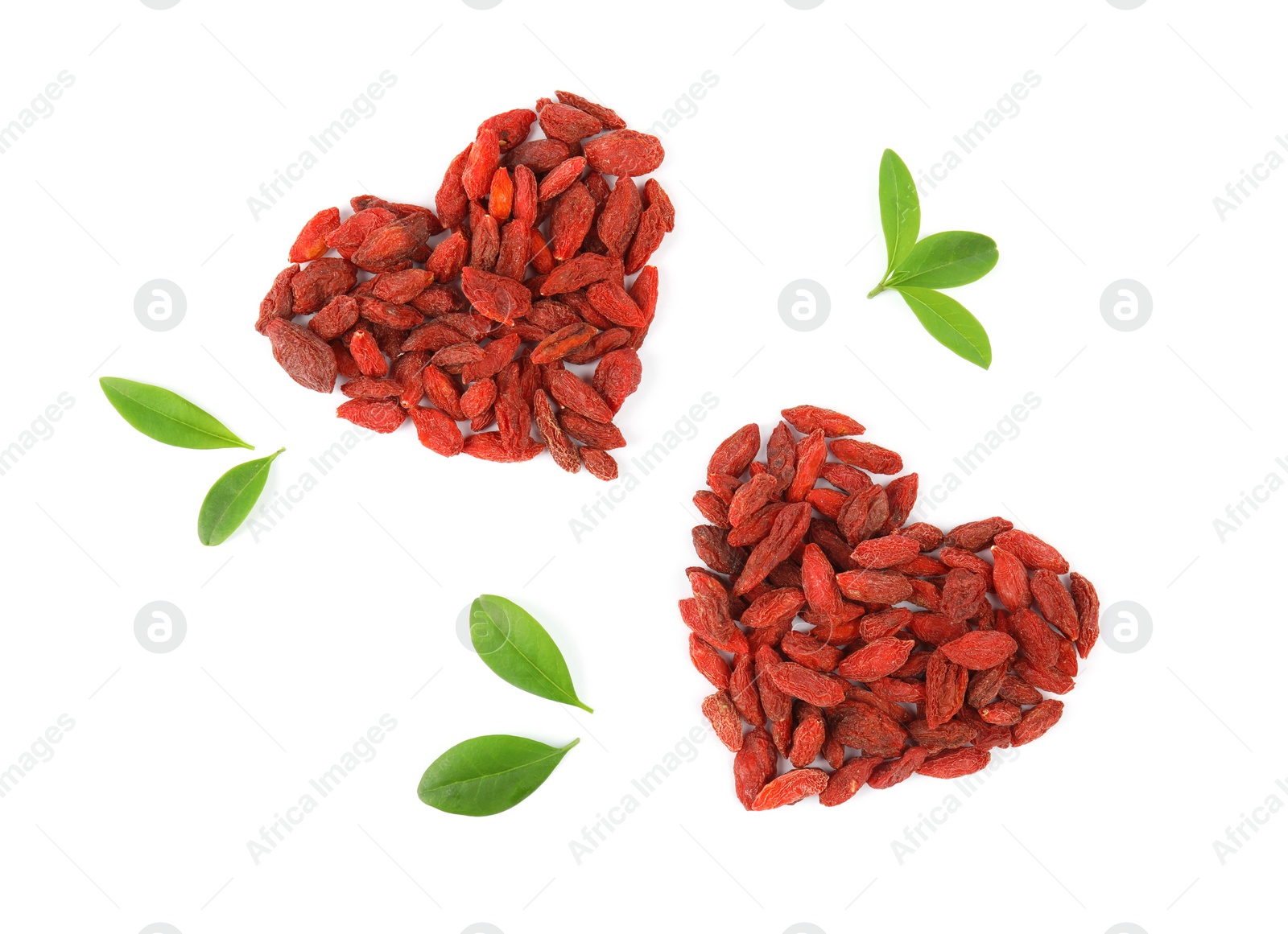 Photo of Heart shaped piles of dried goji berries and leaves on white background, top view