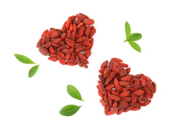 Photo of Heart shaped piles of dried goji berries and leaves on white background, top view