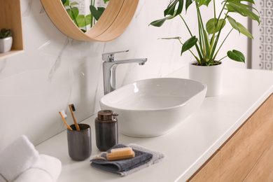 Stylish vessel sink on light countertop in modern bathroom