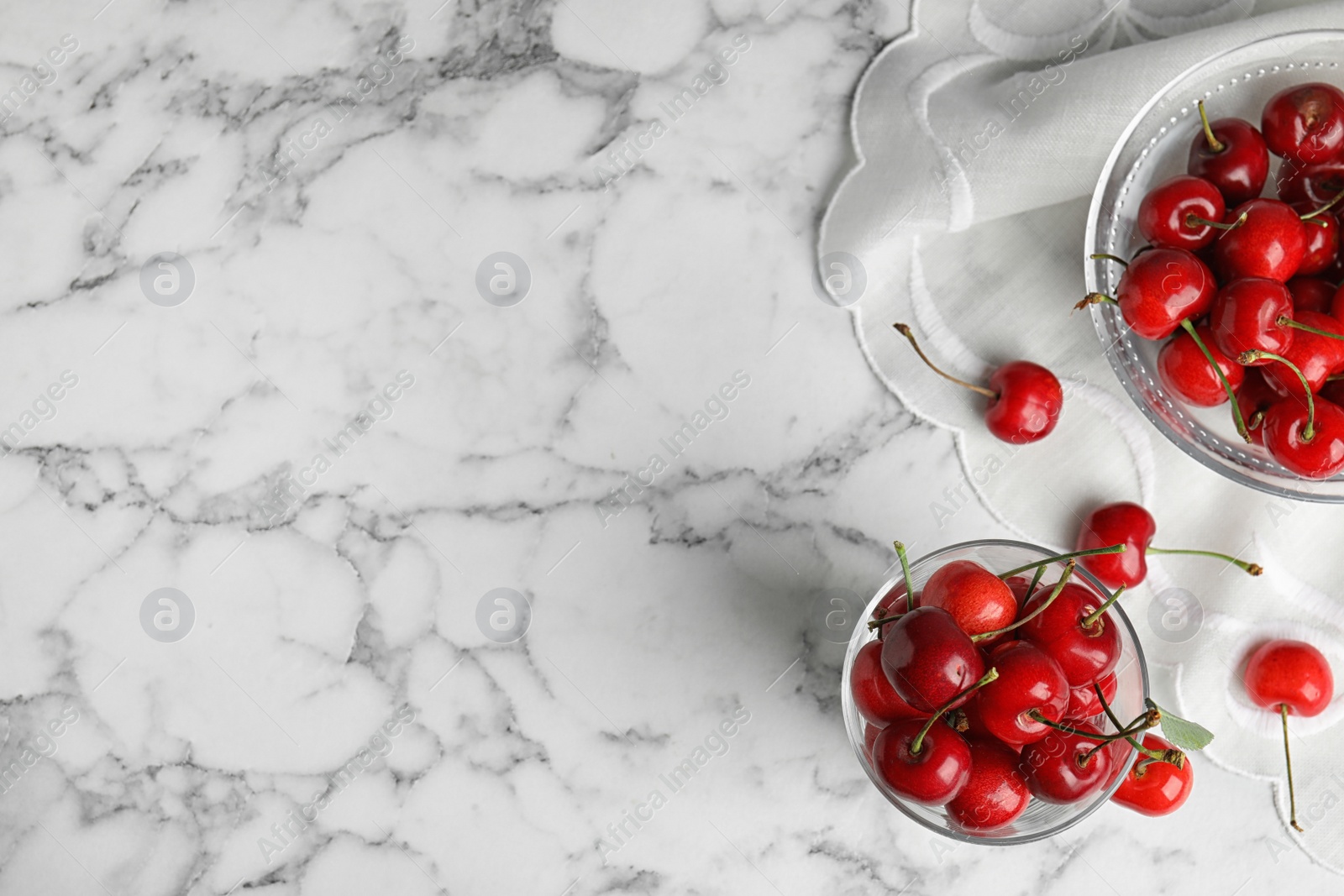 Photo of Flat lay composition with sweet cherries on marble table. Space for text