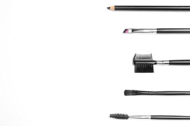 Photo of Set of professional eyebrow tools on white background, top view