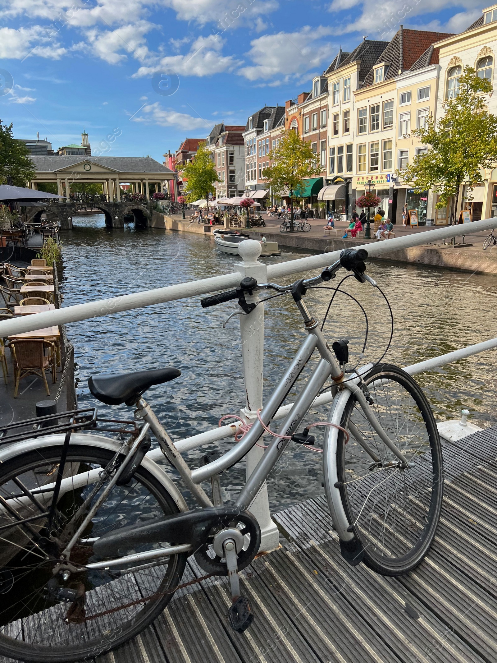 Photo of Beautiful view of bicycle on pedestrian bridge near canal in city