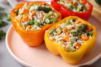 Photo of Tasty stuffed bell peppers on table, closeup