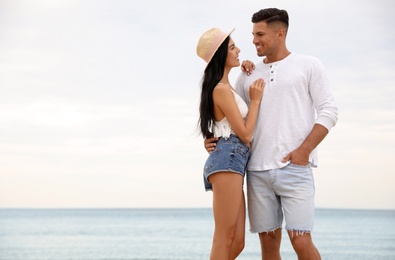 Lovely couple spending time together on beach. Space for text