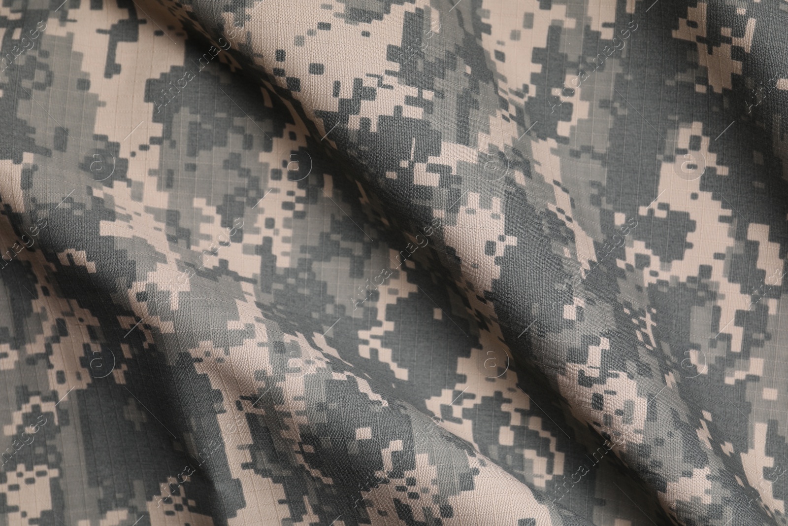 Photo of Texture of crumpled camouflage fabric as background, top view