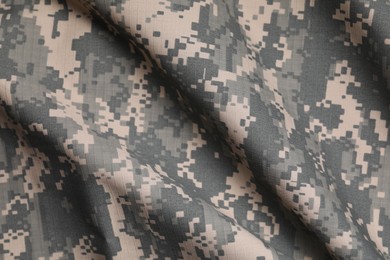 Texture of crumpled camouflage fabric as background, top view