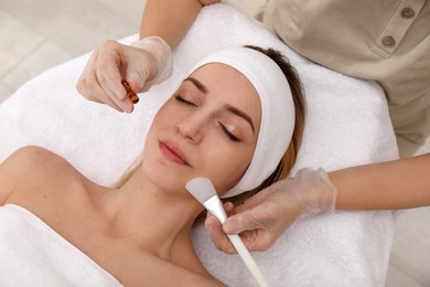 Young woman during face peeling procedure in salon