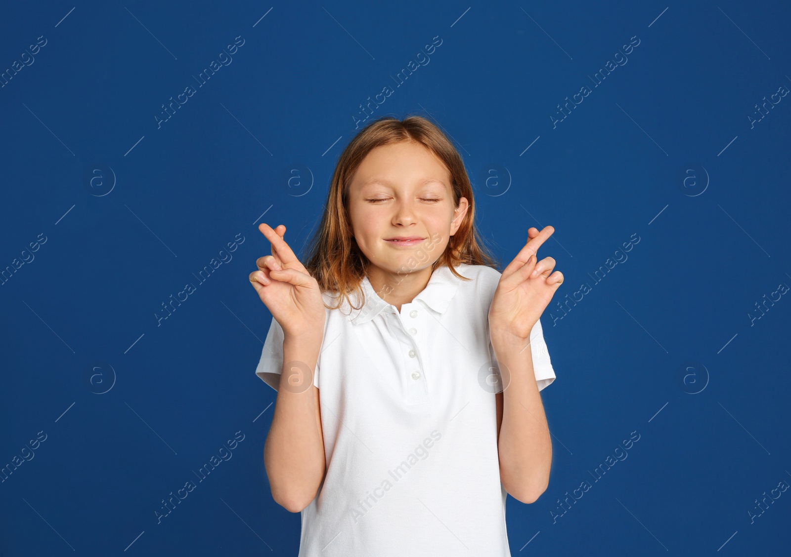 Photo of Portrait of emotional preteen girl on blue background