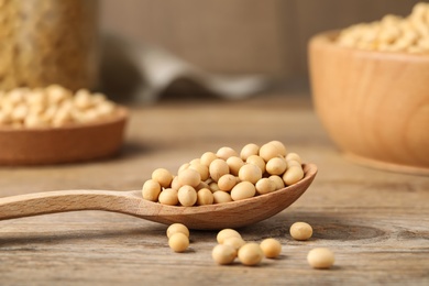 Photo of Natural soy beans on wooden table, closeup