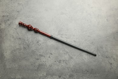 Magic wand on light grey background, top view