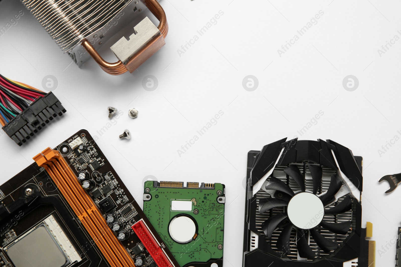 Photo of Graphics card and other computer hardware on white background, flat lay. Space for text
