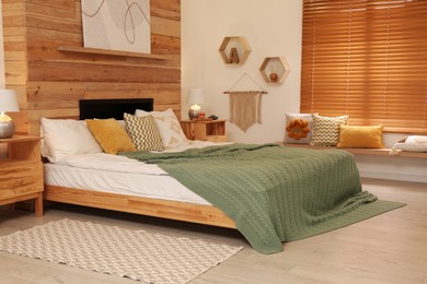 Stylish room interior with big comfortable bed