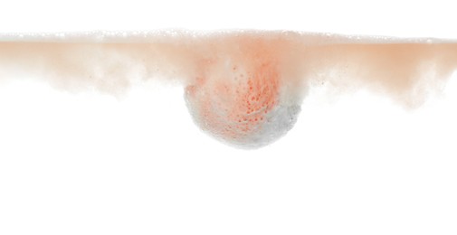 Photo of Bath bomb in water on white background