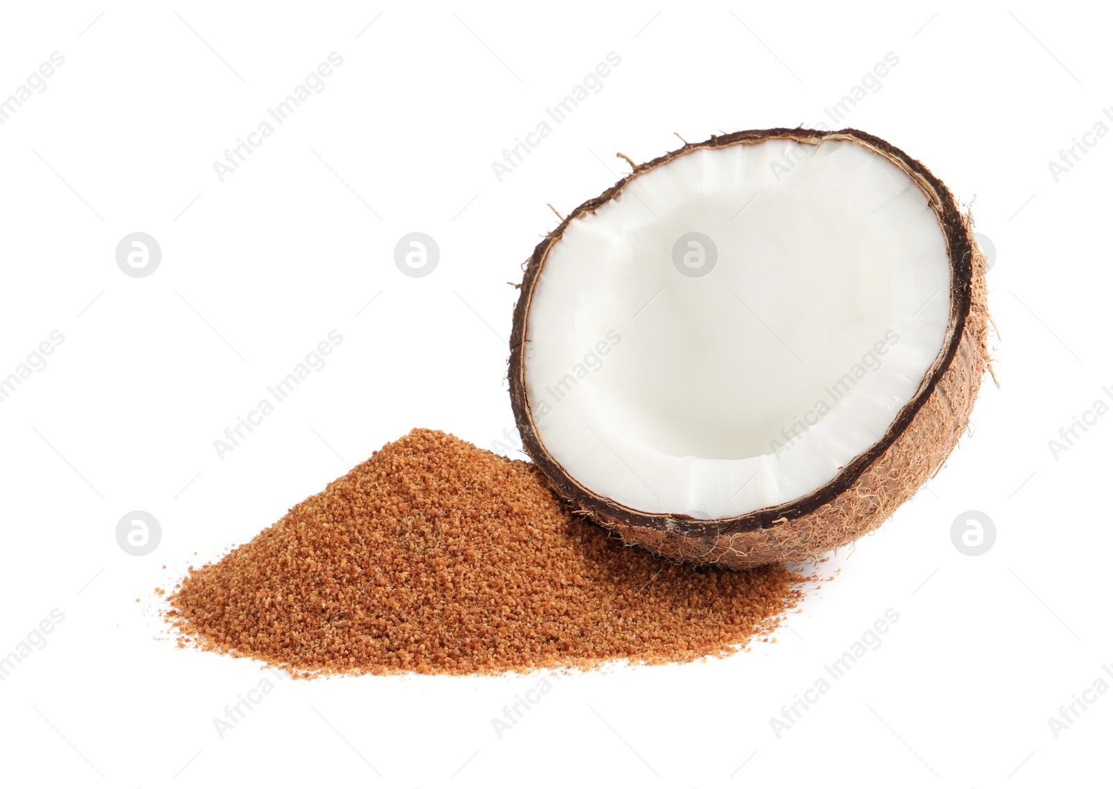 Photo of Ripe coconut and pile of brown sugar on white background