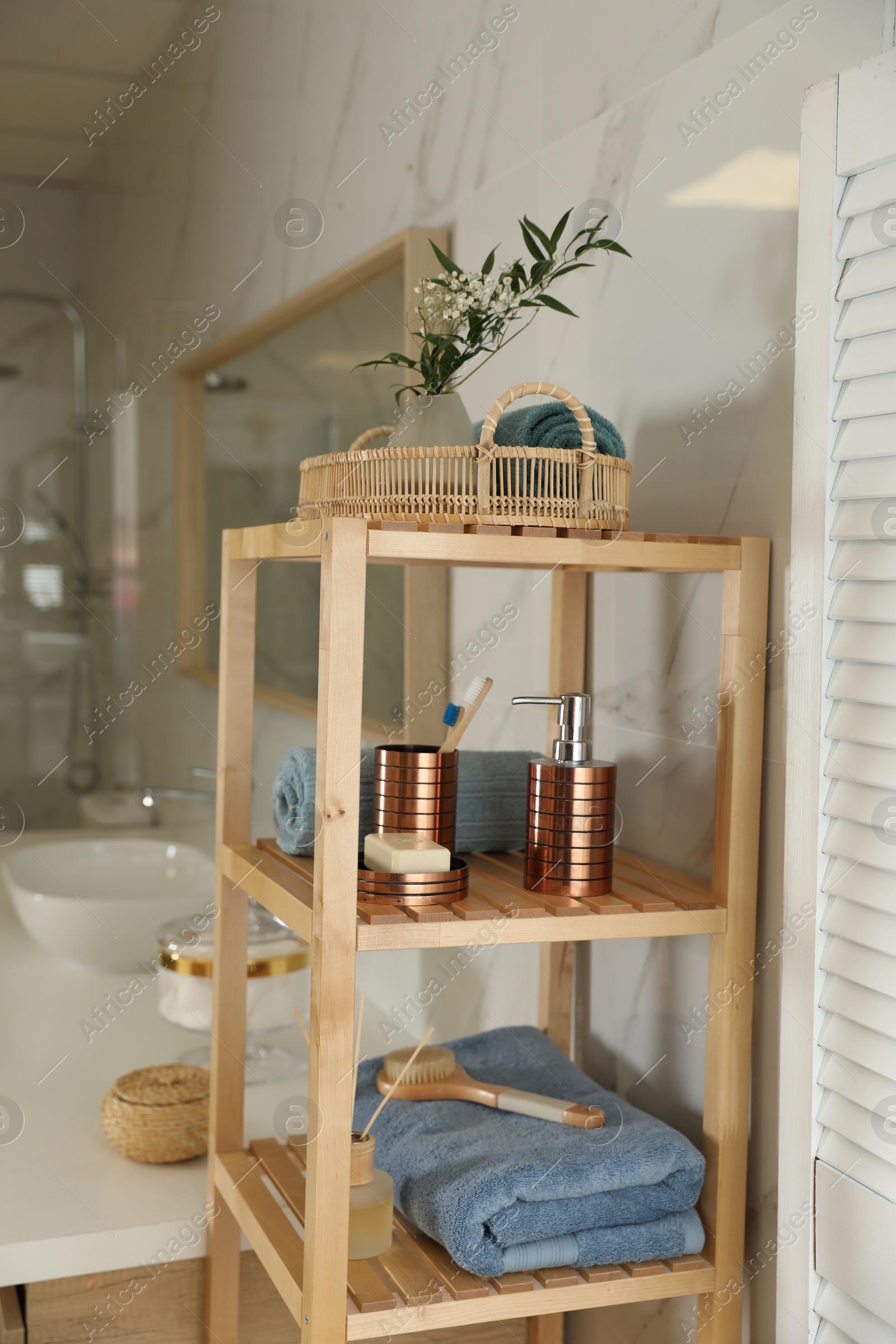 Photo of Shelving unit with toiletries in stylish bathroom interior 