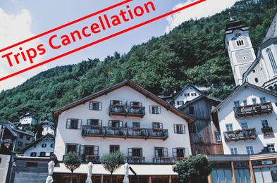 Image of Trips cancellation during coronavirus quarantine. Town with beautiful buildings near mountain forest