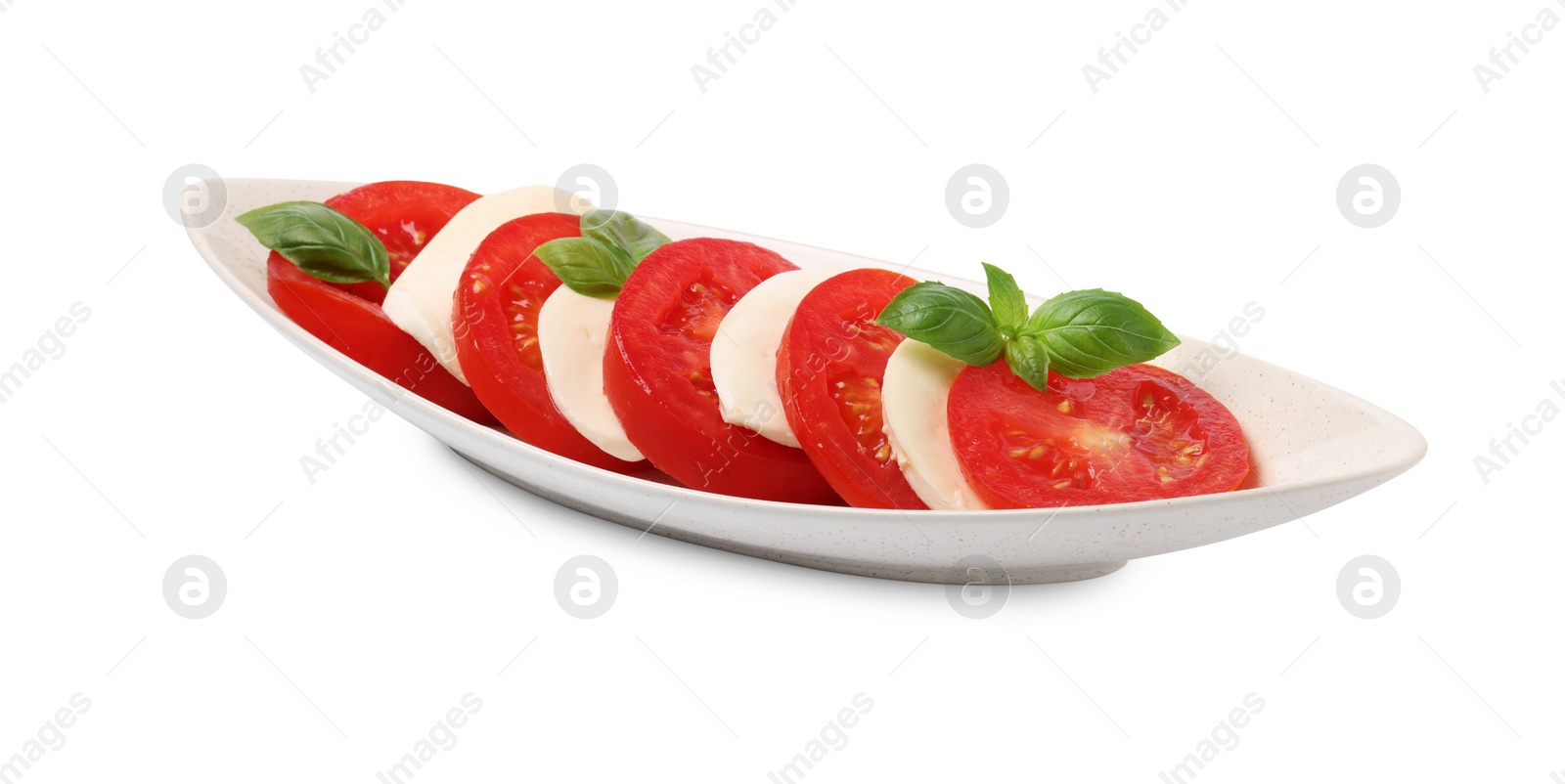 Photo of Plate of delicious Caprese salad with tomatoes, mozzarella and basil isolated on white