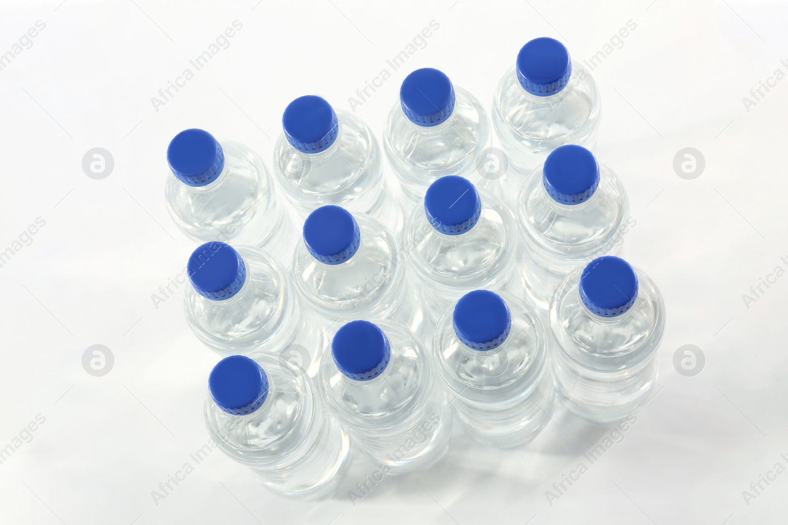 Photo of Plastic bottles with pure water on white background