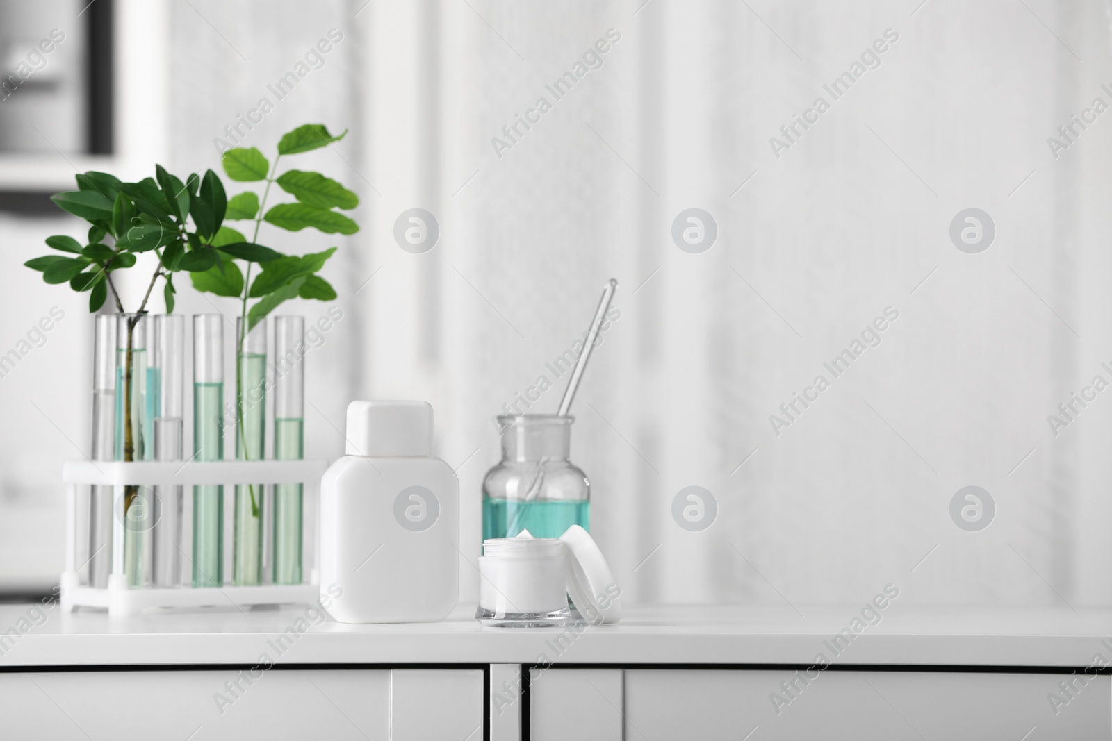Photo of Many containers and glass tubes with leaves on white lab drawer indoors, space for text
