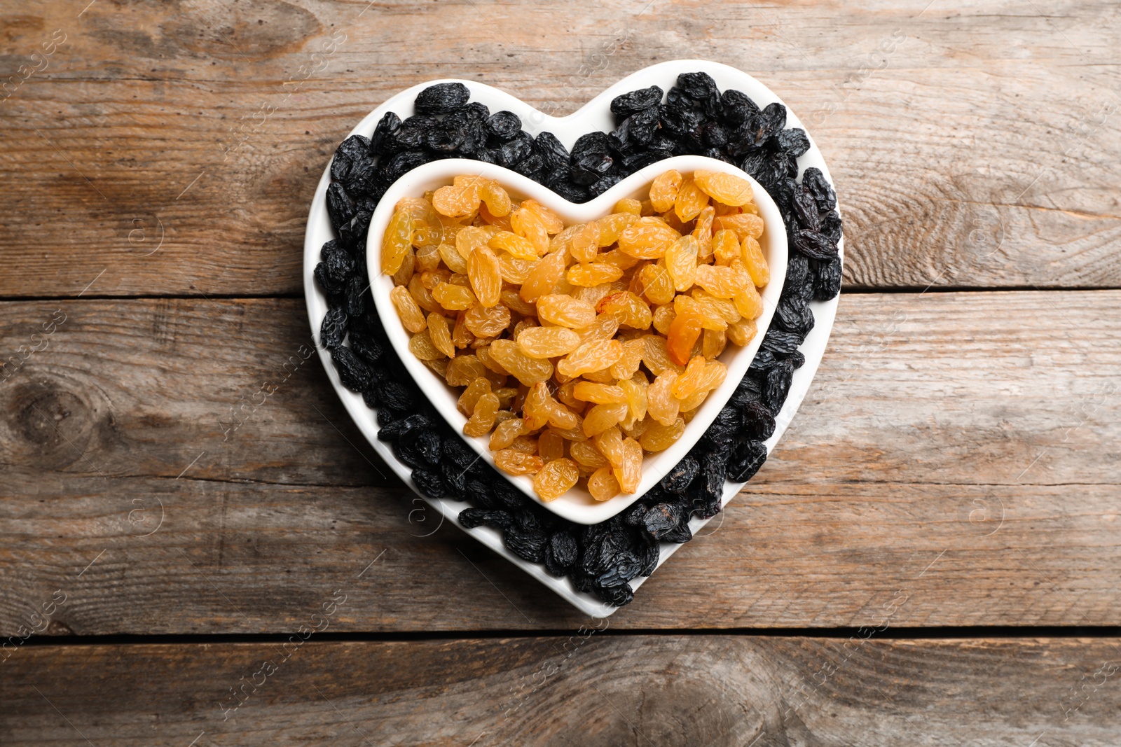 Photo of Flat lay composition with raisins on wooden background. Dried fruit as healthy snack