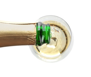 Pouring champagne from bottle into glass on white background, top view. Festive drink