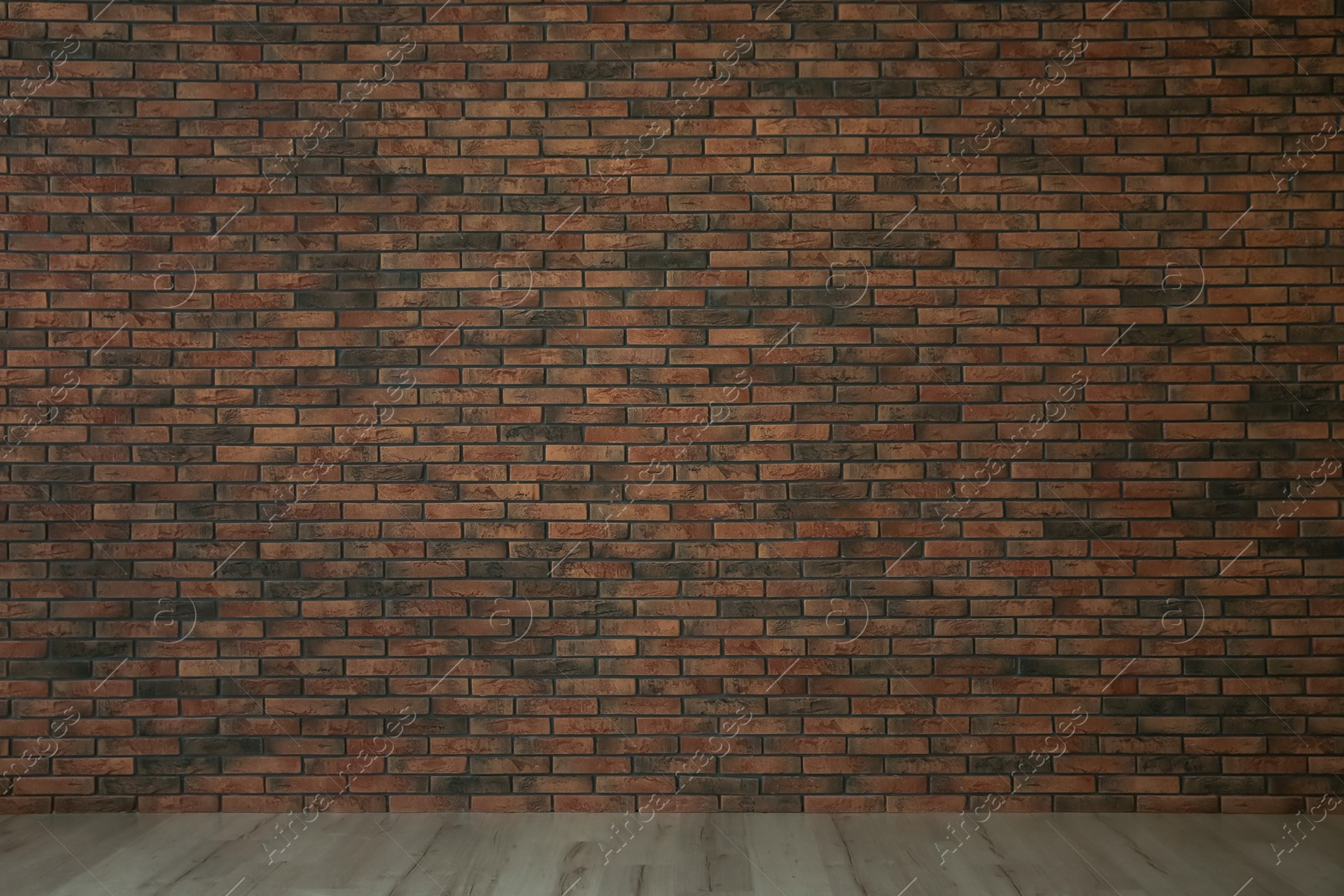 Photo of Empty room with red brick wall and wooden floor